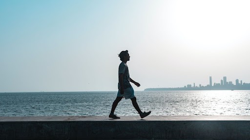 Man Walking By The Ocean
